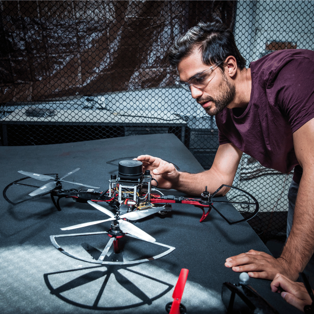 student working on a drone